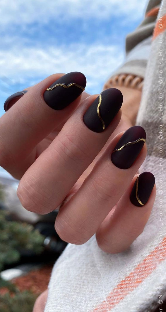 burgundy and gold nail art , burgundy and gold nail art designs, nail trends 2021, oval-shped nail designs 2021, nail art designs, dark nail colours