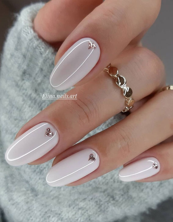 small heart on white nails, silver love heart on pink nails, minimalist valentines nails, valentine's day nails 2021, nude nails, nude nails with love heart, simple valentine's nails, simple valentines nails