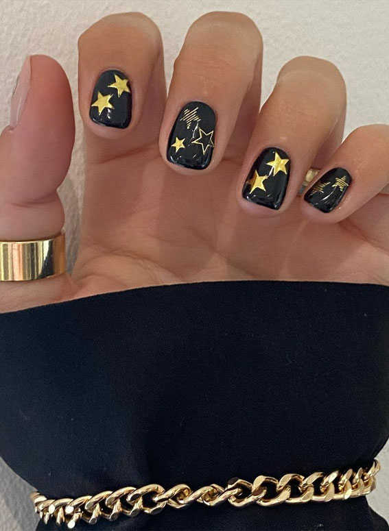 Stylish black nail art designs to keep your style on track : Gold Star Black Nails