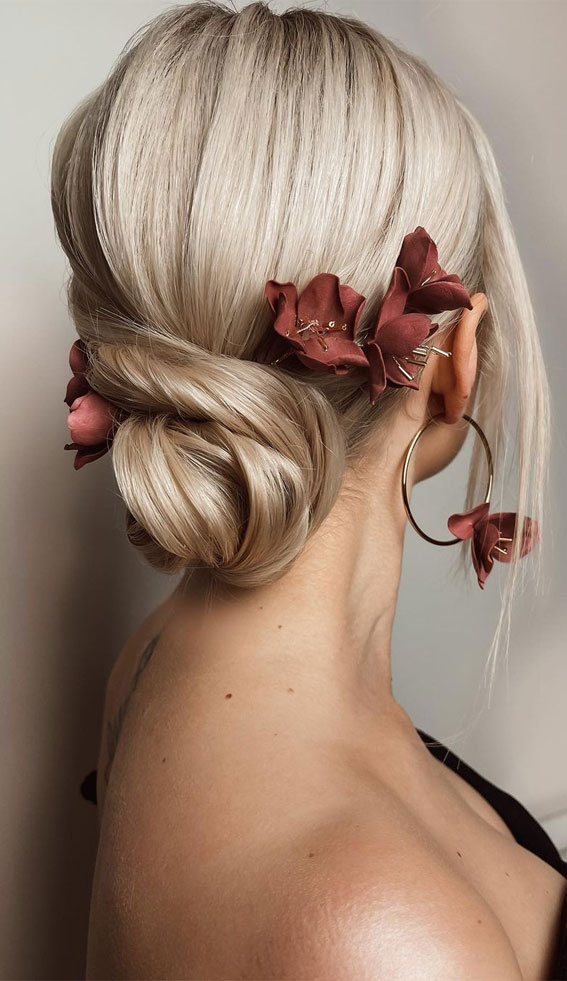 57 Different Wedding Hairstyles For Any Length : Twisted Bun with Burgundy Flower