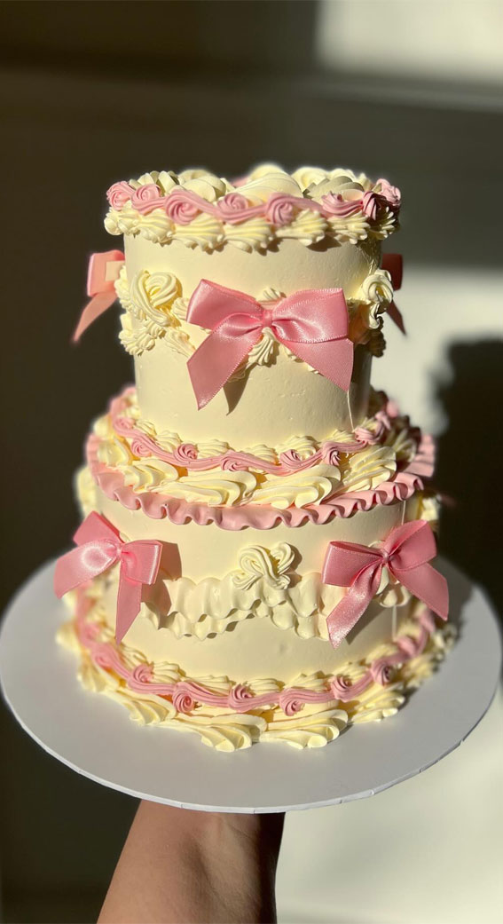 30 Celebrate Cake Ideas for Every Occasion : Two Tiered Vanilla Cake with Pink Bows