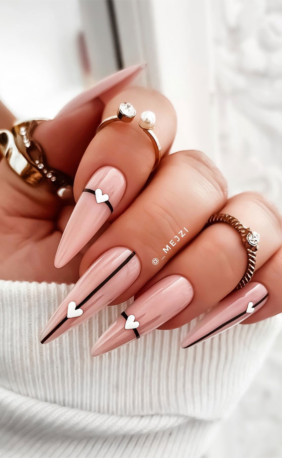 Captivating Valentine’s Day Nail Designs : Stiletto Nude Nails with Love Heart Accents