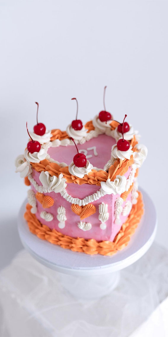 50 Birthday Cake Ideas for Every Celebration : Pink Heart Cake with Orange and White Accents