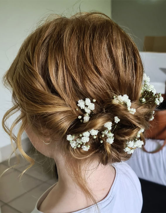 28 Enchanting Flower Girl Hairstyles : Messy Low Bun with Baby’s Breath