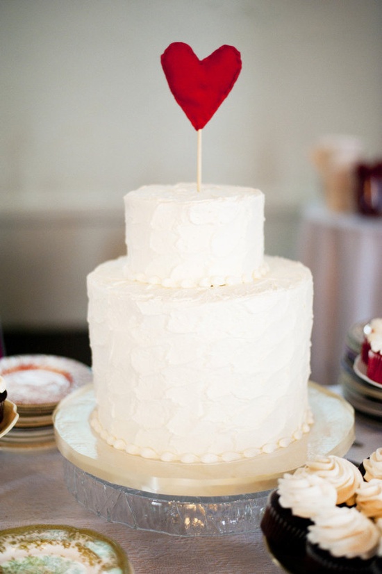 white wedding cake with red heart cake topper, heart topped wedding cake