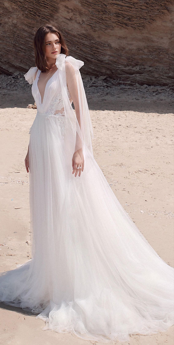 airy ball gown with a low plunging V neckline and sheer sides