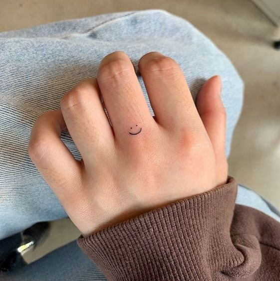 75 Unique Small Tattoo Designs & Ideas : Smiley Face on Finger