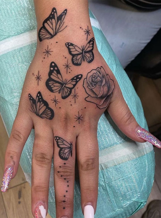 30 Cute Butterfly Tattoos : Butterflies on the hand with a rose covering up a scar