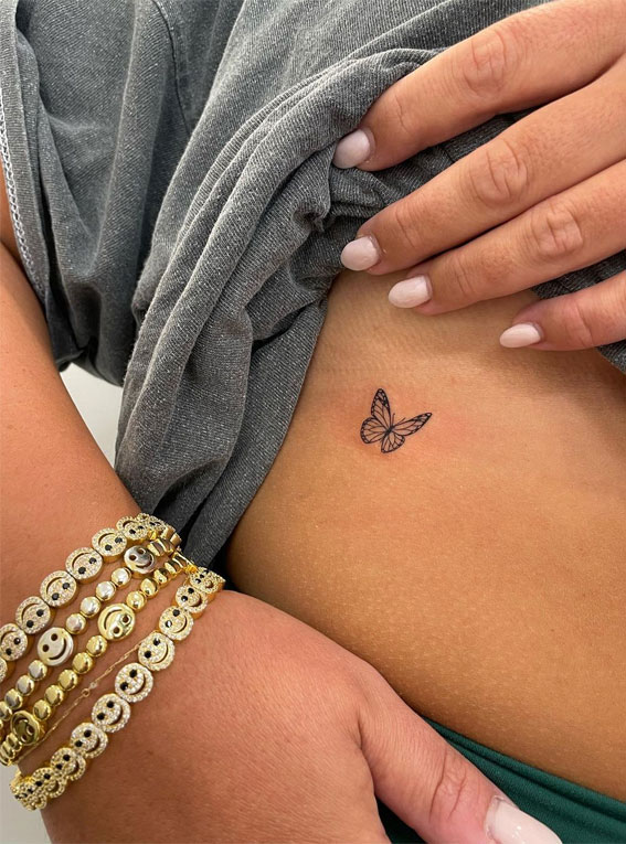 FIne line butterfly tattoo on the hip