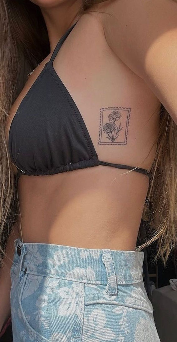 50 Small Tattoo Ideas Less is More : Flower Stamp Tattoo on Side Chest