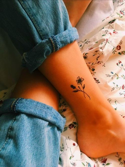 Fine line flower bouquet tattoo on the ankle.