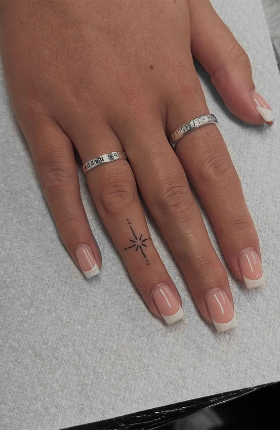 50 Small Tattoo Ideas Less is More : A Star Tattoo on 4th Finger