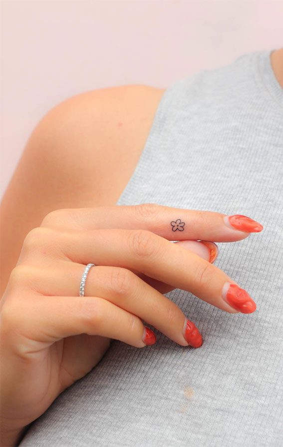 Tiny Treasures Meaningful Small Tattoo Inspirations : Tiny Flower inside Finger