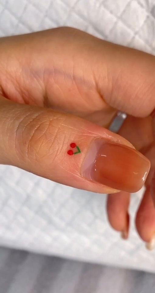 Tiny Treasures Meaningful Small Tattoo Inspirations : Cherries on Thumb