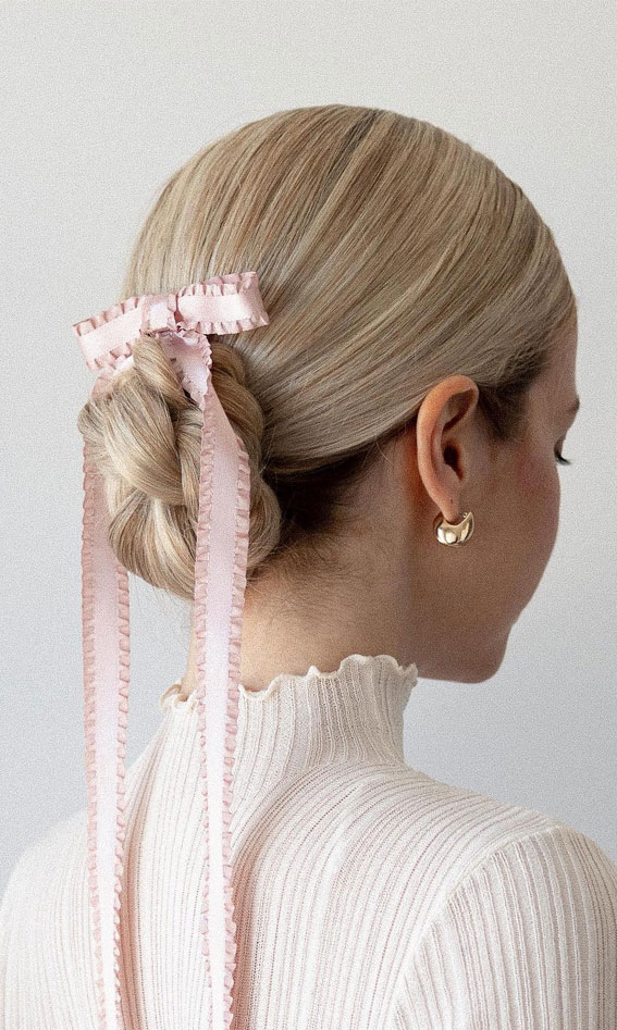 On-Trend Bow Hairstyles for a Chic and Playful Look : Cute Pink Bow Tied Up Sleek Low Bun