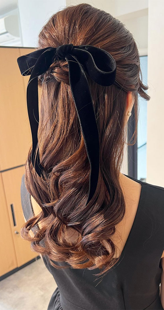 On-Trend Bow Hairstyles for a Chic and Playful Look : Voluminous Half Up with Black Bow