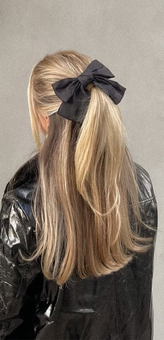 On-Trend Bow Hairstyles for a Chic and Playful Look : Half-Up Twist with Black Bow
