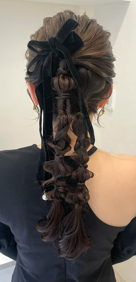 On-Trend Bow Hairstyles for a Chic and Playful Look : Modern Messy Braids Topped with Bows