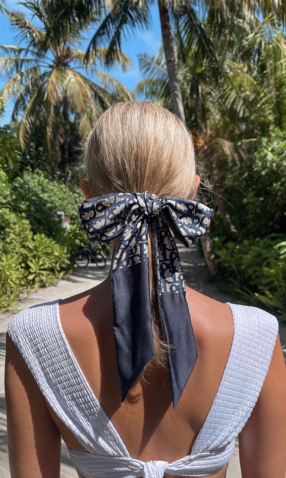 On-Trend Bow Hairstyles for a Chic and Playful Look : Low Ponytail with Dior Oversized Bow