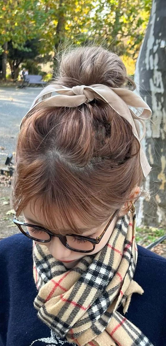 On-Trend Bow Hairstyles for a Chic and Playful Look : Top Knot Bun with Nude Bow