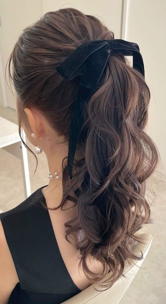 On-Trend Bow Hairstyles for a Chic and Playful Look : Soft Waves Ponytail with Black Velvet Bow